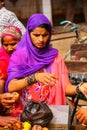 Local woman buying apples at the street market in Fatehpur Sikri, Uttar Pradesh, India. Royalty Free Stock Photo