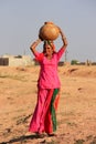 Local woman carrying jar with water on her head, Khichan village