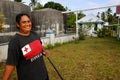 Local woman cleaning church yard, Ofu island, Tonga