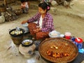 Local woman cooking in the street of Mingun, Mandalay, Myanmar