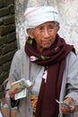 Local woman counting money in the street, Mingun, Mandalay region, Myanmar