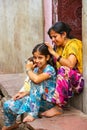 Local woman grooming for lice on her daughter`s head in Fatehpur