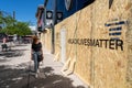 Local Woman Looking at Boarded Up Storefront With Black Lives Matter Message, Toronto, Canada Royalty Free Stock Photo