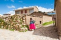 Local woman in national clothing walking on Island of Sun Isla del Sol on Titicaca lake, Bolivia Royalty Free Stock Photo