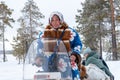 A local woman in a national costume drives a snowmobile