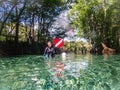 Local woman scuba diver tows dive flag through the shallow aqua spring waters, Ginnie Springs, Florida Royalty Free Stock Photo