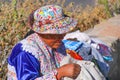 Local woman sitting at Mirador Cruz del Condor in Colca Canyon, Royalty Free Stock Photo