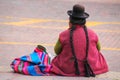 Local woman sitting at Plaza de Armas in Cusco, Peru