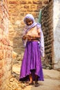 Local woman standing in a narrow street in Fatehpur Sikri, Uttar Pradesh, India