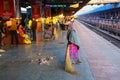 Local woman sweeping at Jaipur Junction railway station in Rajasthan, India.