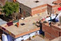 Local woman walking on a flat roof of the house in Jaipur