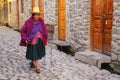 Local woman walking in the street of Ollantaytambo, Peru