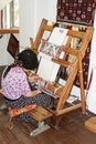 Local woman weaves a carpet by hand in Antalya, Turkey