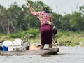 Local woman working on Mokoro to deliver tourists and campers across the rivers of the Delta Okawango, Botswana Royalty Free Stock Photo