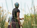 Local woman working on Mokoro to deliver tourists and campers across the rivers of the Delta Okawango, Botswana Royalty Free Stock Photo