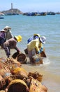 Local women are cleaning their baskets which were used for transporting fishes from the boat to the truck