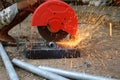 Local worker with electric circular steel cutting machine and sparkle