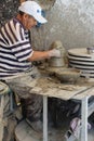 A local worker forms a ceramic piece in Fez, Morocco.