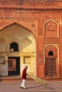 Local worker sweeping courtyard of Jahangiri Mahal in Agra Fort, Uttar Pradesh, India