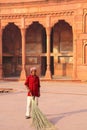 Local worker sweeping courtyard of Jahangiri Mahal in Agra Fort, Uttar Pradesh, India Royalty Free Stock Photo