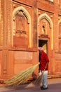 Local worker sweeping courtyard of Jahangiri Mahal in Agra Fort, Uttar Pradesh, India Royalty Free Stock Photo