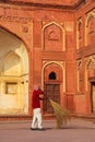 Local worker sweeping courtyard of Jahangiri Mahal in Agra Fort, Uttar Pradesh, India Royalty Free Stock Photo