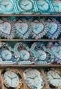 Locally made decorative wall clocks kept in racks for sale in a Indian market