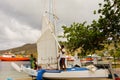 A locally made traditional sailboat being rigged for a regatta