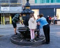 Locals drinking water from the Canaletas fountain