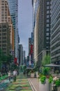 Locals enjoying a early summer day in Garment District Urban Garden un Broadway inbetween skyscrapers of Manhattan