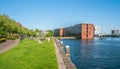 Locals enjoying the sun on a grass field on the waterside of the IJhaven IJ Harbor on the Java eiland Java Island a new develo