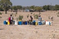 Locals Filling Water Canisters at a Well in Rural Namibia Royalty Free Stock Photo