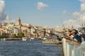 Locals fishing at Galata Bridge with city skyline in the background, including Galata Tower, Eminonu, Istanbul, Turkey Royalty Free Stock Photo