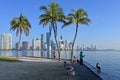 Locals fishing Rickenbacker Causeway with Miami, Florida skyline in background.