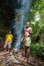 Locals of the island New Guinea have dinner and made fire to cook food.