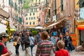 Locals and tourists in busy typical Italian street in small Cinque Terre hillside village