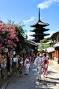 Locals and tourists dressed up in Kimonos, strolling through the vibrant Geisha district of Gion in Kyoto, Japan.