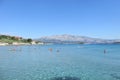 Locals and tourists enjoying a beautiful summer day along the sandy beaches of Lumbarda Beach on Korcula Island, Croatia Royalty Free Stock Photo