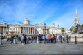 Locals and tourists gathering and hanging out at Trafalgar Square in front of National Gallery in London, England, UK Royalty Free Stock Photo