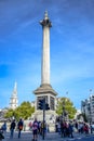 Locals and tourists hanging out at Nelson`s Column at Trafalgar Square in the City of Westminster, Central London, England, UK Royalty Free Stock Photo