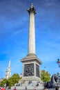 Locals and tourists hanging out at Nelson`s Column at Trafalgar Square in the City of Westminster, Central London, England, UK