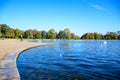 Tourists hanging out at a round pond in front of Kensington Palace in London, England Royalty Free Stock Photo