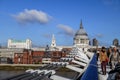 Tourists walking and crossing Millennium Bridge with St Paul`s Cathedral in background, London, England, United Kingdom Royalty Free Stock Photo
