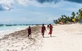 Locals of zanzibar walking towards their fishing boats Royalty Free Stock Photo