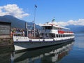 Paddle-wheel steam boat moored ready to cruise at promenade on alpine Lake Maggiore landscape in Locarno at Switzerland