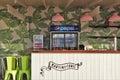 Outdoor bar with counter and pepsi fridge.