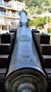 Ancient cannon directed to modern building Royalty Free Stock Photo