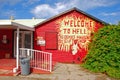 The main entrance of a small gift shop with strong red paint in Cayman Island within the rock formation area called Hell