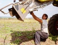 Repair of equipment, a farmer makes a harvester, work in the field