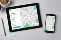 Location tracker concept on tablet and smartphone screen. GPS ma